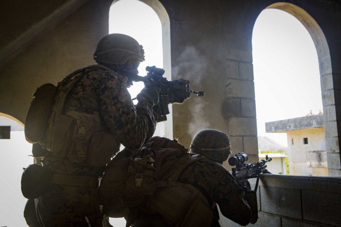 Lance Cpl. Hans Hagy, a squad leader, and Lance Cpl. Alexis Diaz, a machine gunner with Echo Co., Battalion Landing Team, 2nd Battalion, 5th Marines, 31st Marine Expeditionary Unit, engage simulated targets while participating in a mechanized raid as part of Amphibious Integrated Training (AIT) at Marine Corps Base Camp Butler, Okinawa, Japan, March 15, 2017. AIT assimilates the capabilities of the 31st MEU Marine Air-Ground Task Force and the amphibious ships of the Bonhomme Richard Amphibious Ready Group to conduct ship to shore operations. As the Marine Corps' only continuously forward-deployed unit, the 31st Marine Expeditionary Unit's air-ground-logistics team provides a flexible force, ready to perform a wide range of military operations, from limited combat to humanitarian assistance operations, throughout the Indo-Asia-Pacific region. (U.S. Marine Corps photo by Cpl. Darien J. Bjorndal)