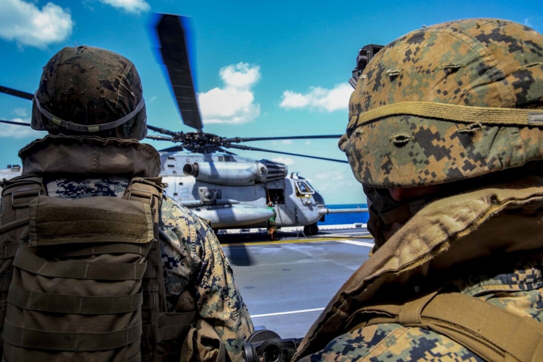 Marines with Weapons Company, Battalion Landing Team 2nd Battalion, 5th Marines, 31st Marine Expeditionary Unit move to the flight deck during a Tactical Recovery of Aircraft and Personnel exercise, aboard the USS Bonhomme Richard (LHD 6), in the Pacific Ocean, March 15, 2017. Marines and Sailors of the 31st MEU embarked aboard the USS Bonhomme Richard (LHD 6), part of the Bonhomme Richard Amphibious Readiness Group, as part of their annual spring patrol of the Indo-Asia-Pacific region. The 31st MEU, embarked on the amphibious ships of the Expeditionary Strike Group 7, has the capability to respond to any crisis or contingency at a moment’s notice. (U.S. Marine Corps photo by Cpl. Jona R. Meme)