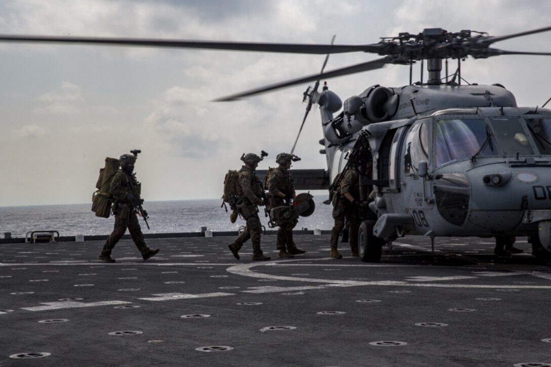 Marines with Maritime Raid Force, 31st Marine Expeditionary Unit, load up on a Navy MH-60 Seahawk during a vessel Visit, Board, Search and Seizure exercise aboard the USNS Richard E. Byrd (T-AKE-4) in the Pacific Ocean, March 17, 2017. The MRF specializes in ground and amphibious reconnaissance operations and limited scale raids as the primary reconnaissance and battlespace shaping element of the 31st MEU. 31st MEU conducts VBSS training as a part of the 31st MEU’s 17.1 Spring Patrol of the Asia-Pacific region. As the Marine Corps’ only continuously forward deployed unit, the 31st MEU’s air-ground-logistics team provides a flexible force, ready to perform a wide range of military operations, from limited combat to humanitarian assistance operations, throughout the Asia-Pacific region. (U.S. Marine Corps photo by Cpl. Jona R. Meme/Released)