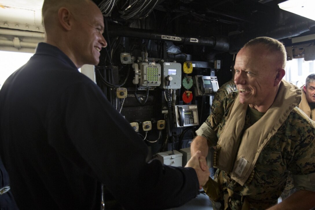 U.S. Marine Lt. Gen. Lawrence D. Nicholson, commanding general of III Marine Expeditionary Force, is greeted by U.S. Navy Capt. Nathan Moyer, commanding officer of the USS Green Bay (LPD 20), underway in the Pacific Ocean, March 21, 2017. Nicholson spoke with Marines and Sailors of the 31st Marine Expeditionary Unit, a III MEF component currently aboard ships of the Bonhomme Richard Amphibious Ready Group. As the Marine Corps' only continuously forward-deployed unit, the 31st MEU air-ground-logistics team provides a flexible force, ready to perform a wide range of military operations, from limited combat to humanitarian assistance operations, throughout the Indo-Asia Pacific region. (U.S. Marine Corps photo by Cpl. Darien J. Bjorndal) 