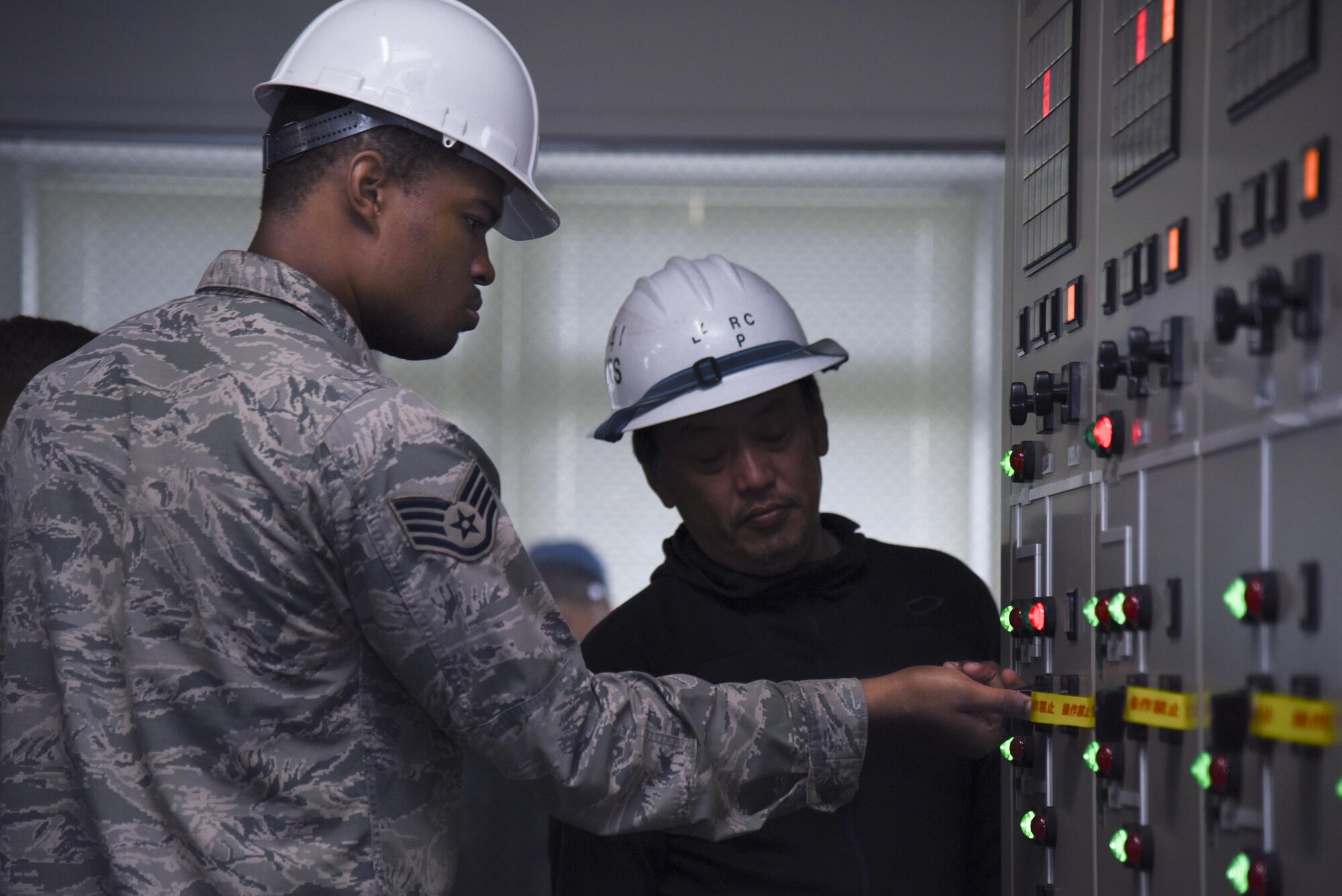 Staff Sgt. Quintin Robinson, 374th Civil Engineer Squadron electrical shop exterior NCO in charge, turns off a substation circuit breaker before repairing a high-voltage transformer in the West Substation at Yokota Air Base, Japan, April 8, 2017. In order to repair a high-voltage transformer, power needed to be down for about 19 hours and it affected certain parts of the main and west side of the base. (U.S. Air Force photo by Machiko Arita)