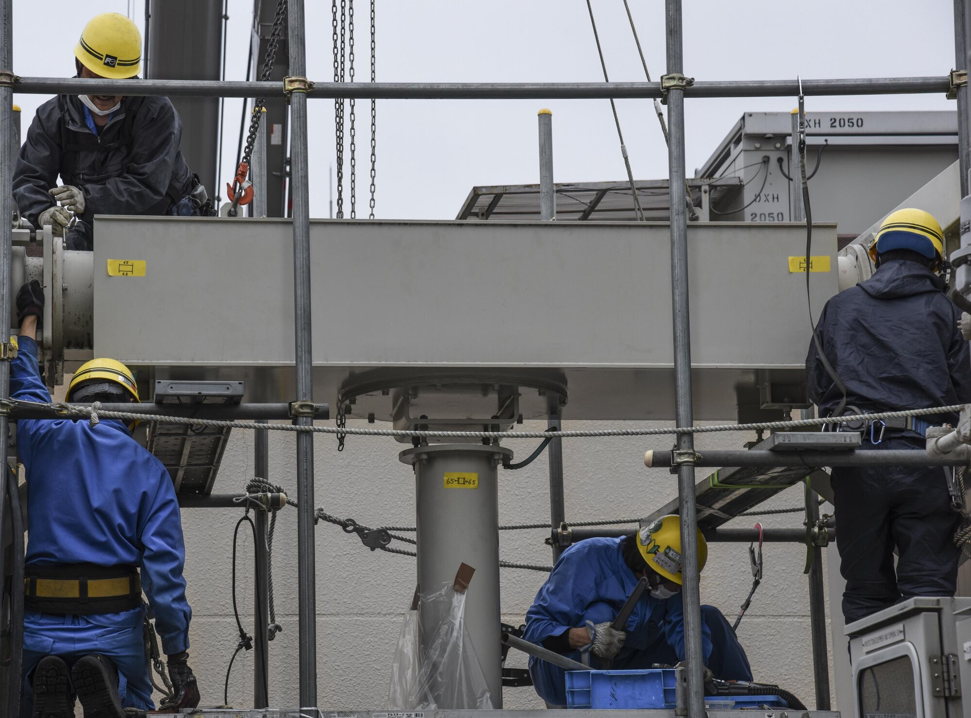 Contractors from Fuji Electric System Company, Limited work to remove a busbar on the gas-insulated high-voltage switchgear from which gas leaked at Yokota Air Base, Japan, April 8, 2017.The 374th Civil Engineer Squadron along with the contractors repaired the gas leak from one of the gas-insulated high-voltage switchgear in the West Substation to prevent further damage. (U.S. Air Force photo by Machiko Arita)