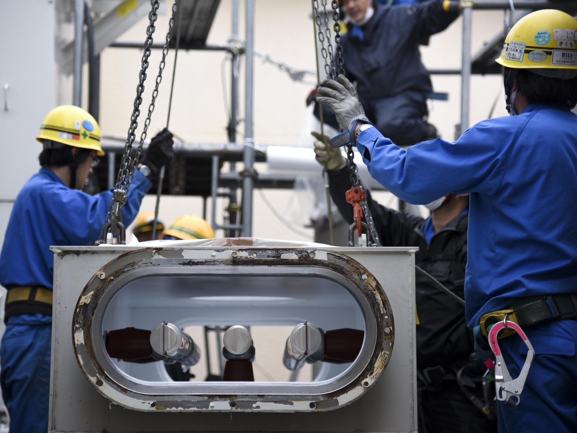 Contractors from Fuji Electric System Company, Limited take a busbar down at Yokota Air Base, Japan, April 8, 2017. During the power outage, the 374th Civil Engineer Squadron and contractors de-energized the transformers, removed the remaining gas from the busbar on the gas-insulated high-voltage switchgear, deconstructed the busbar, repaired a rusty flange and replaced a gasket of the busbar. (U.S. Air Force photo by Machiko Arita)