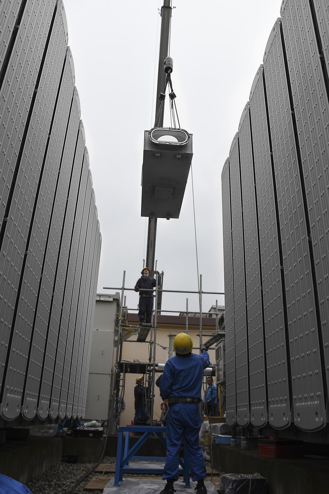 A crane lifts a busbar to provide repairs at Yokota Air Base, Japan, April 8, 2017. During the power outage, the 374th Civil Engineer Squadron and contractors de-energized the transformers, removed the remaining gas from the busbar on the gas-insulated highvoltage switchgear, deconstructed the busbar, repaired a rusty flange and replaced a gasket of the busbar. (U.S. Air Force photo by Machiko Arita)