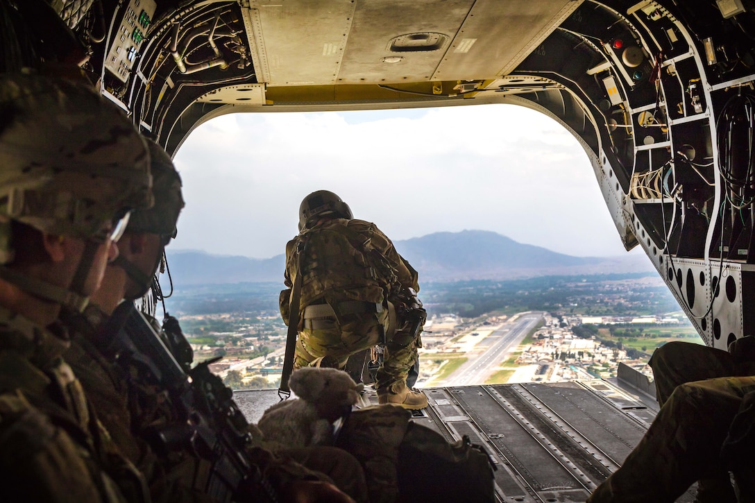 An Army crew chief scans the ground for clearance from the ramp of a CH-47 Chinook helicopter while flying near Jalalabad, Afghanistan, April 5, 2017. Army photo by Capt. Brian Harris