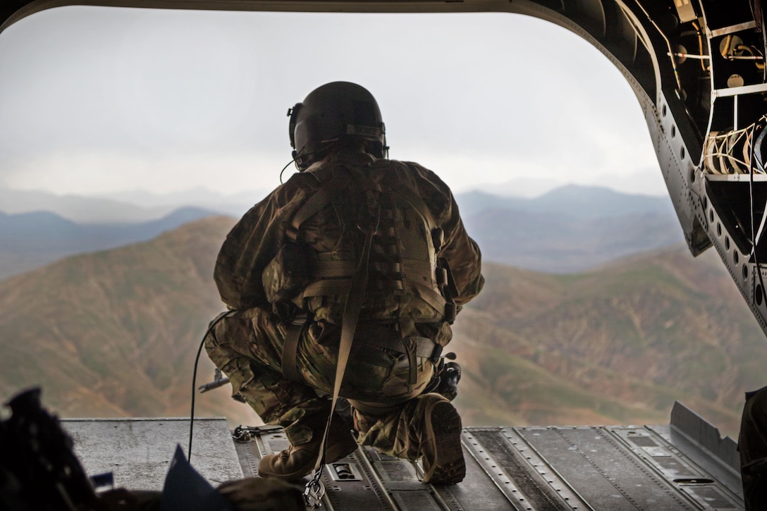 An Army crew chief scans the mountains fom the ramp of a CH-47 Chinook helicopter while flying near Jalalabad, Afghanistan, April 5, 2017. Army photo by Capt. Brian Harris