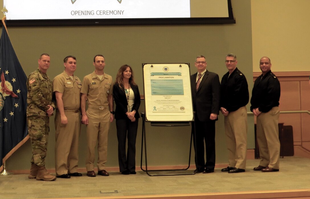 NSA Philadelphia senior leaders, including DLA Troop Support Deputy Commander Richard Ellis (right of proclamation), stand together after signing the Sexual Assault Awareness Month proclamation during a ceremony April 4. There will be activities on base throughout the month to raise awareness about sexual assault.