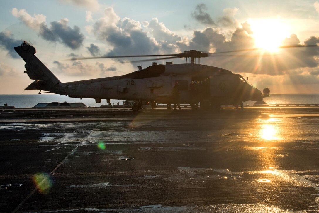 A Navy MH-60R Seahawk helicopter prepares to take off from the flight deck of the aircraft carrier USS Carl Vinson in the South China Sea, April 8, 2017. The helicopter crew is assigned to Maritime Strike Squadron 78. Navy photo by Petty Officer 3rd Class Matt Brown