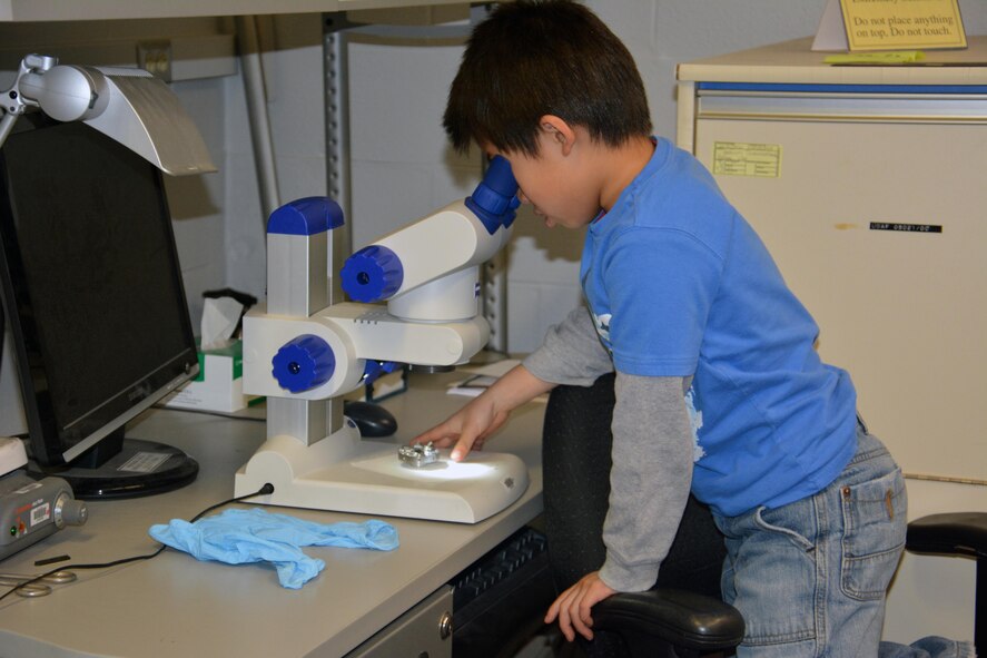 A budding scientist explores some research tools on display during the Materials and Manufacturing Directorate Open House, April 7. More than 200 guests, family members and friends of the laboratory participated in the inaugural Open House event, held in celebration of its 100 year anniversary this year. (U.S. Air Force photo/David Dixon)

EDITOR'S NOTE:  Parental Minor Release signed 12 April 2017