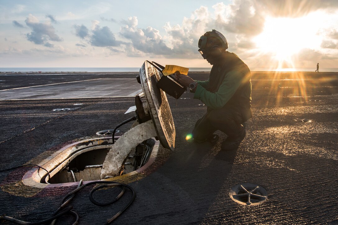 Navy Seaman Ronnie Jennings writes in a log during preflight operational checks from the flight deck aboard the aircraft carrier USS Carl Vinson in the South China Sea, April 8, 2017. Jennings is an airman. Navy photo by Petty Officer 3rd Class Matt Brown