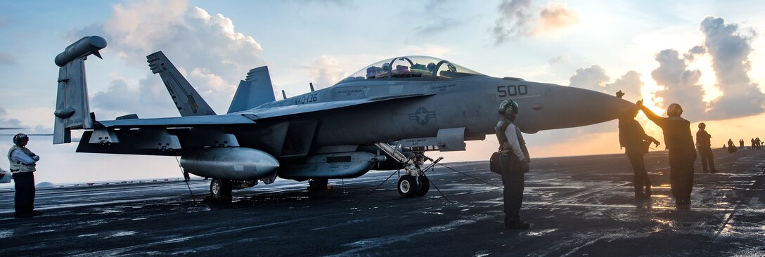Sailors prepare a Navy EA-18G Growler for flight on the flight deck of the aircraft carrier USS Carl Vinson in the South China Sea, April 8, 2017. The aircraft and its crew are assigned to Electronic Attack Squadron 136. Navy photo by Petty Officer 3rd Class Matt Brown