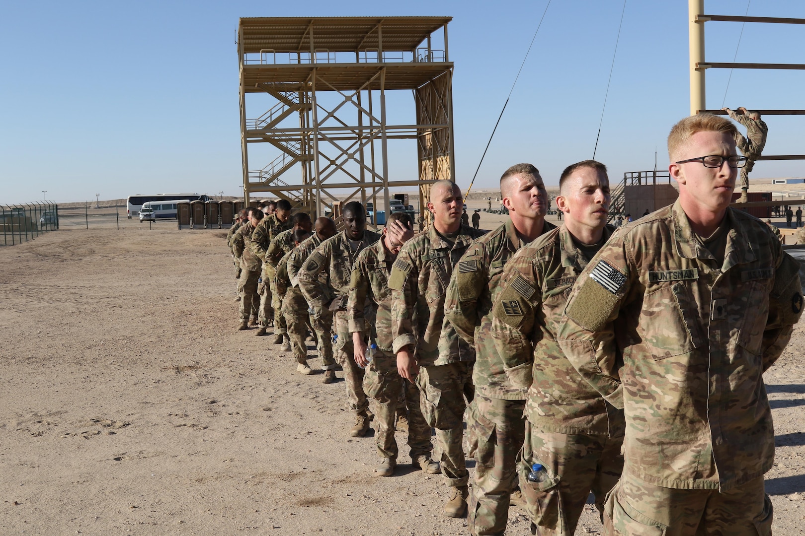 U.S. Servicemembers line up to complete the confidence climb obstacle (right), during day zero of U.S. Army Central’s first Air Assault Course, April 4, 2017, at Camp Beuhring, Kuwait. The Air Assault Course is a 12-day class that allows U.S. military personnel in the USARCENT theater of operations the unique opportunity to become air assault qualified, while deployed outside the continental United States.  “Once completed, the perspective student goes on to become the subject matter expert to their company or unit commander assisting them with planning for air assault operations into whatever environment they may need,” said Capt. Ronald Snyder, Company B commander, Army National Guard Warrior Training Center.