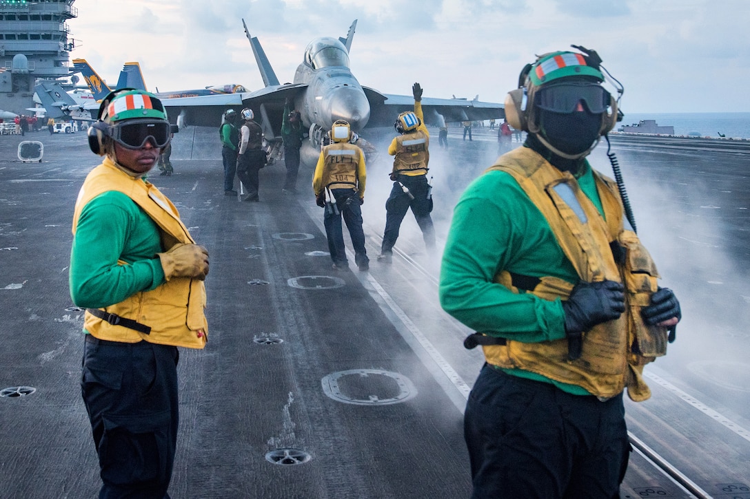 Sailors assigned to the catapult and arresting gear crew observe as an aircraft launches from the flight deck of the aircraft carrier USS Carl Vinson in the South China Sea, April 8, 2017. Navy photo by Petty Officer 3rd Class Matt Brown 