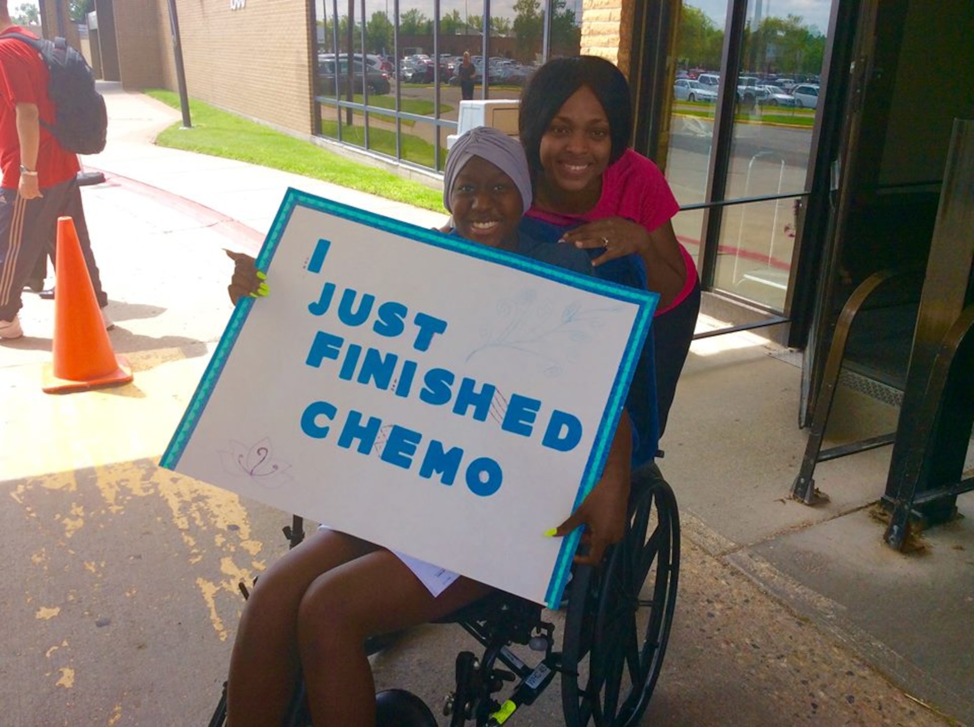 Airman 1st Class Celeste Black, a crew chief with the 69th Maintenance Squadron, celebrates finishing her chemotherapy with Master Sgt. Aisha Wolfgang, the supply management NCO in charge with the 69th MXS. (Courtesy Photo)