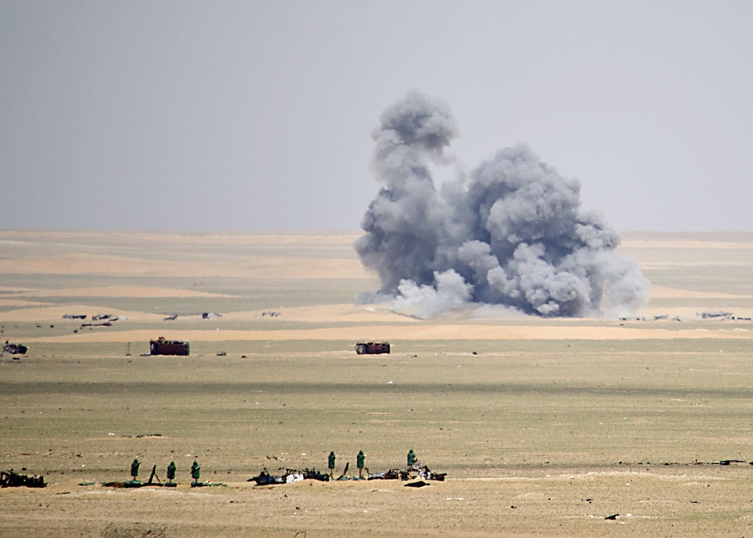 Rounds from a High Mobility Artillery Rocket System hit their target on the im-pact zone during a live-fire gunnery table VI, March 29, Udairi Range Complex, Kuwait. The gunnery was to validate and qualify the three-man teams required to operate each HIMARS. (U.S. Army photo by Capt. Scott Campbell, 29th Infan-try Division Public Affairs)