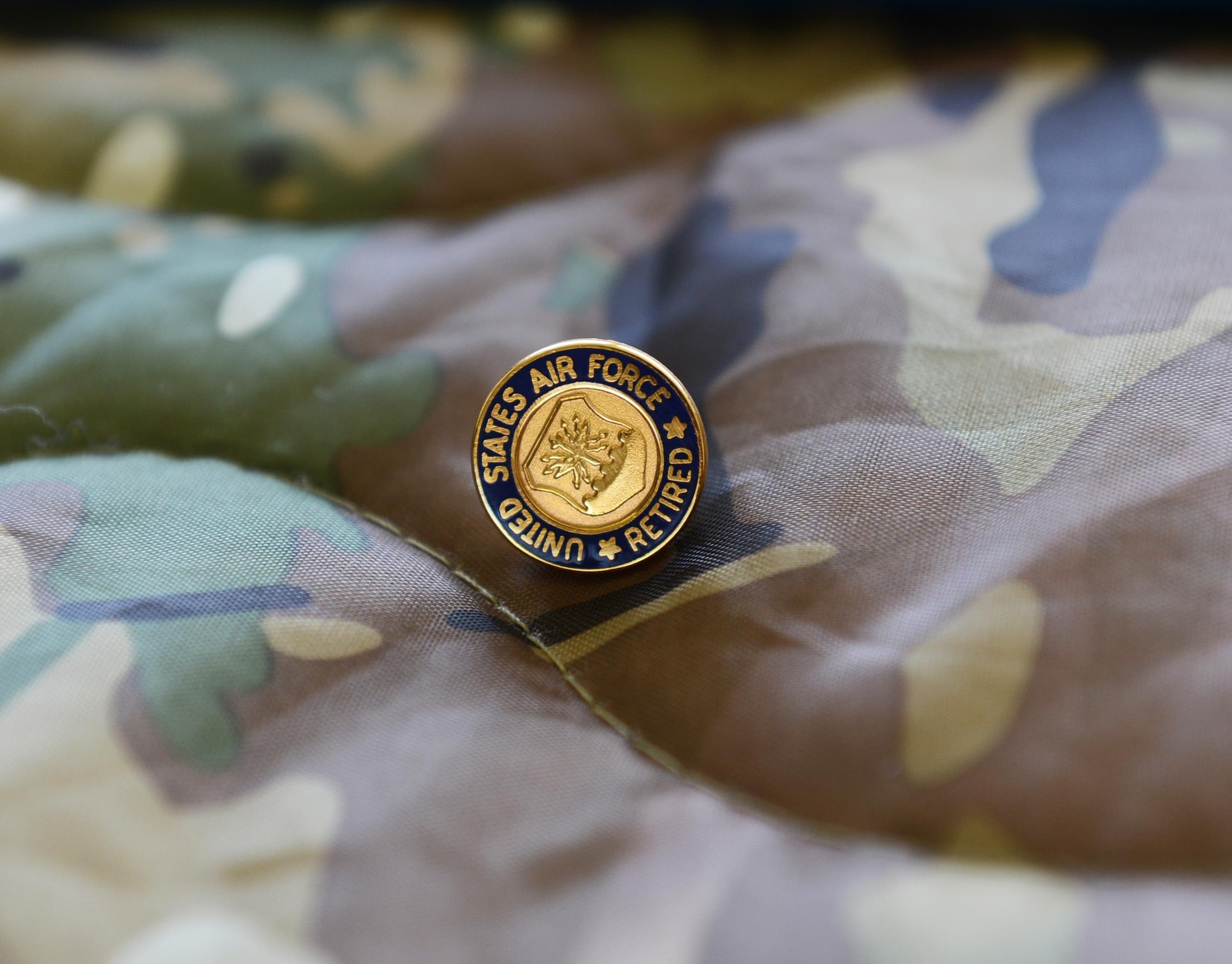 A retirement pin sits on display during Maj. Gen. Eugene Haase’s retirement ceremony at Hurlburt Field, Fla., April 10, 2017. Haase flew 114 combat hours supporting Operations Just Cause, Desert Shield and Desert Storm, Provide Comfort and Allied Force. (U.S. Air Force photo/Staff Sgt. Melanie Holochwost)