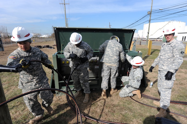 Soldiers with C Company, 249th Engineer Battalion (Prime Power), based out of Fort Belvoir, Virginia, install electrical generator equipment Nov. 6, 2012, at a Carteret, N.J. fuel depot that lost power during Hurricane Sandy. This work was critical to relieving gas shortages experienced by recovering communities in the immediate days following the storm.