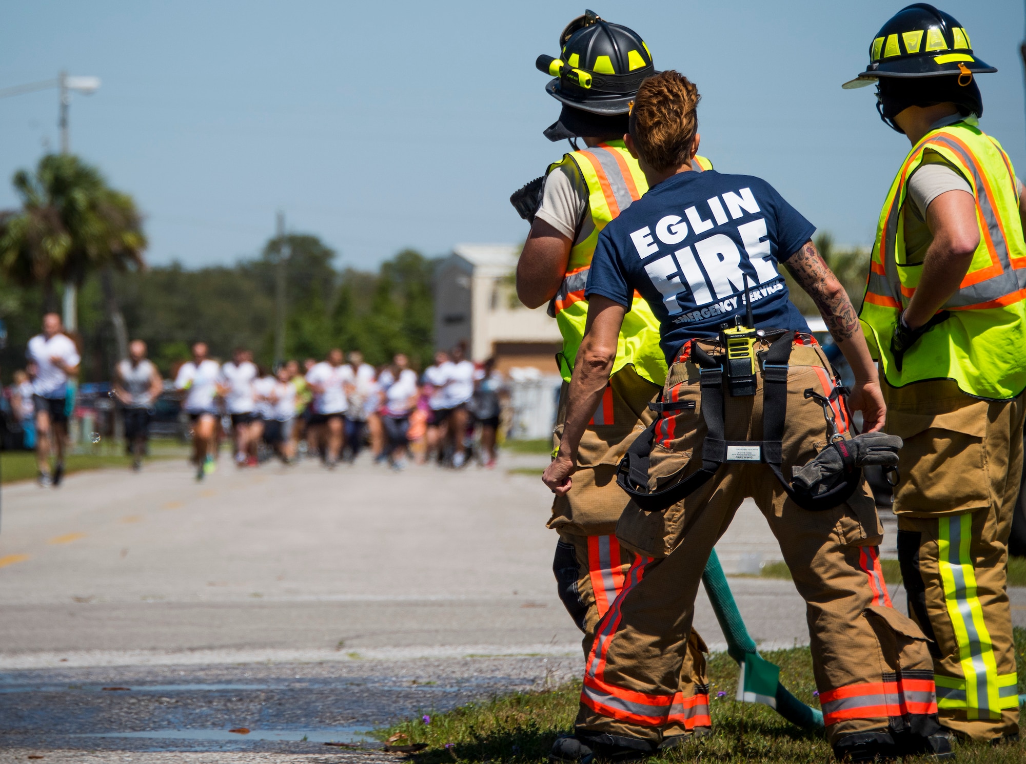 Firefighters prepare to soak participants with water during the 4th annual Color Me Aware Fun Run April 6 near the Civil Engineer Pavilion at Eglin Air Force Base, Fla. The run is held to raise sexual assault awareness. (U.S. Air Force photo/Ilka Cole)