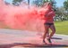 A runner leaves a pink powder trail as she moves toward the finish line during the 4th annual Color Me Aware Fun Run April 6 near the Civil Engineer Pavilion at Eglin Air Force Base, Fla. The run is held to raise sexual assault awareness. (U.S. Air Force photo/Ilka Cole)