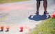 Cups of colored power sit on the pavement ready to be tossed on run participants during the 4th annual Color Me Aware Fun Run April 6 near the Civil Engineer Pavilion at Eglin Air Force Base, Fla. The run is held to raise sexual assault awareness. (U.S. Air Force photo/Ilka Cole)
