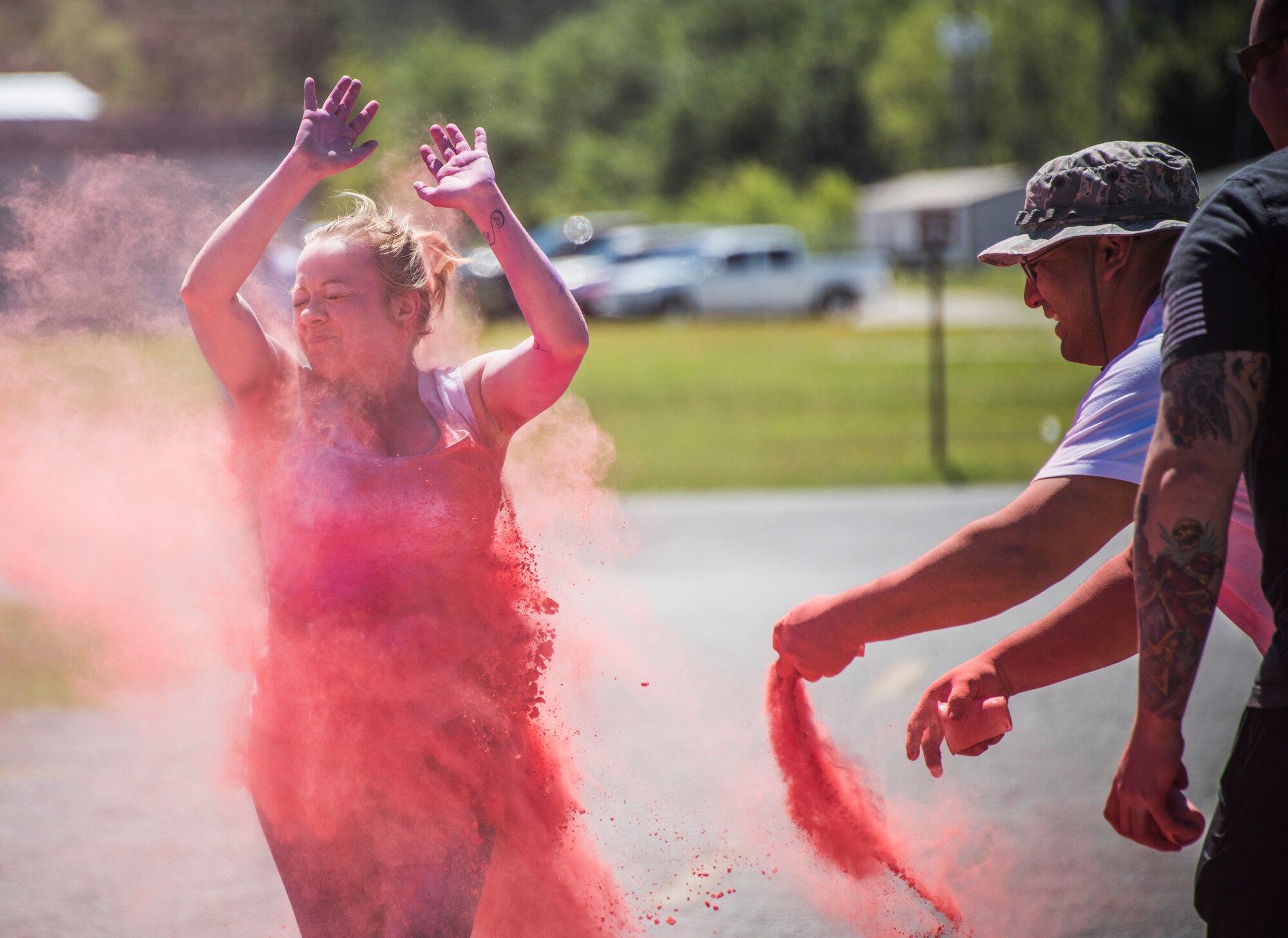 A runner squints through a pink cloud of powder during the 4th annual Color Me Aware Fun Run April 6 near the Civil Engineer Pavilion at Eglin Air Force Base, Fla. The run is held to raise sexual assault awareness. (U.S. Air Force photo/Ilka Cole) 