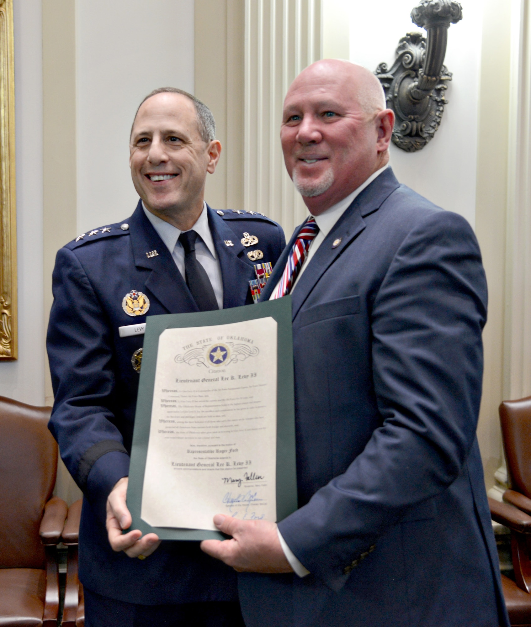 Rep. Roger Ford, R-Midwest City, presents Lt. Gen. Lee K. Levy II, Air Force Sustainment Center Commander, with a proclamation honoring Tinker’s 75th Anniversary. (Air Force photo by Kelly White)