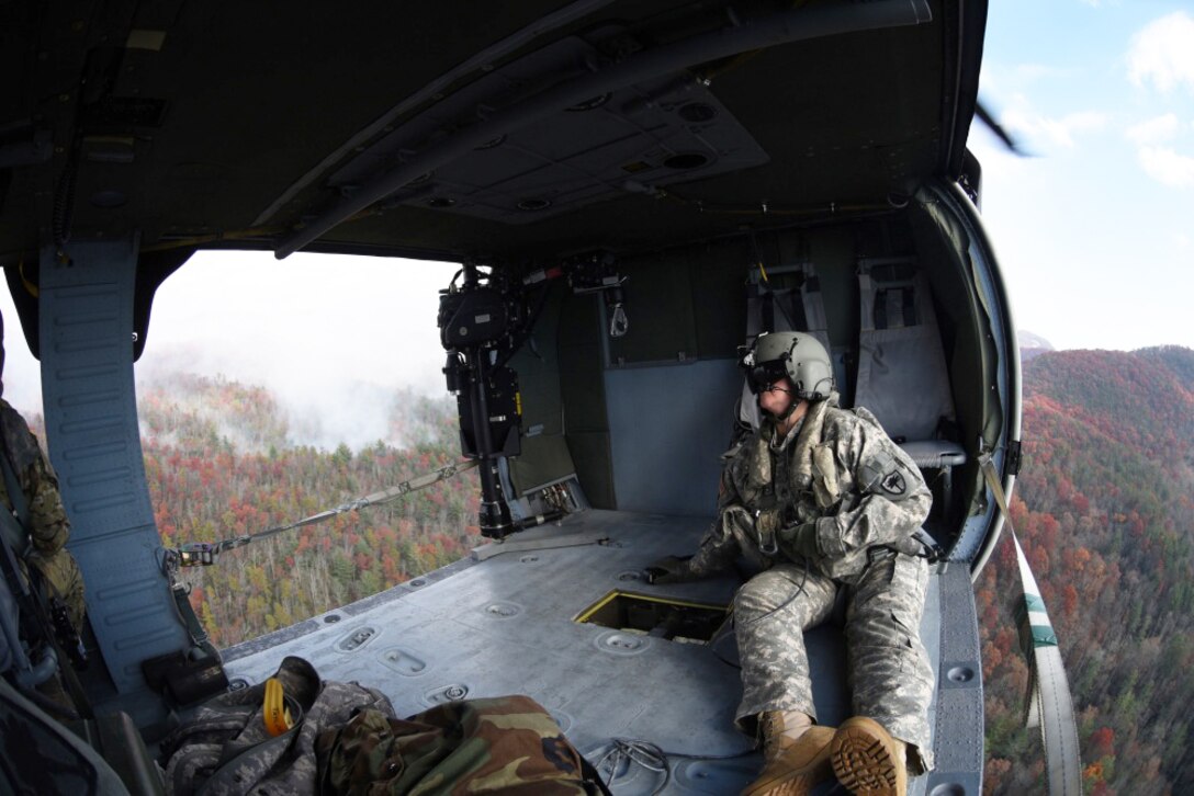 Army Staff Sgt. Jessica Thibeau, with the South Carolina Army National Guard’s 59th Aviation Troop Command, observes from a UH-60 Black Hawk helicopter during efforts to fight South Carolina wildfires, Nov. 24, 2016. South Carolina Army National Guard photo by Staff Sgt. Roberto Di Giovine