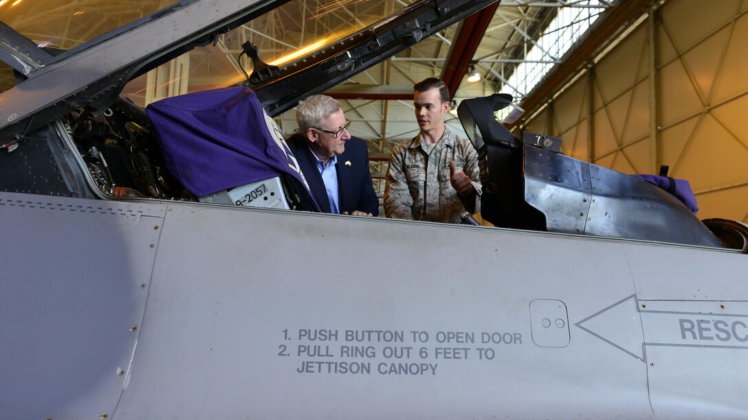 Paul Mitchell, Michigan congressman, learns about the F-16 Fighting Falcon from Staff Sgt. Mark Allen, 31st Aircraft Maintenance Squadron avionics systems craftsman, at Aviano Air Base, Italy, April 8, 2017. Nine state representatives visited Aviano AB to meet base leaders and residents from their respective states. (U.S. Air Force photo by Senior Airman Cary Smith)