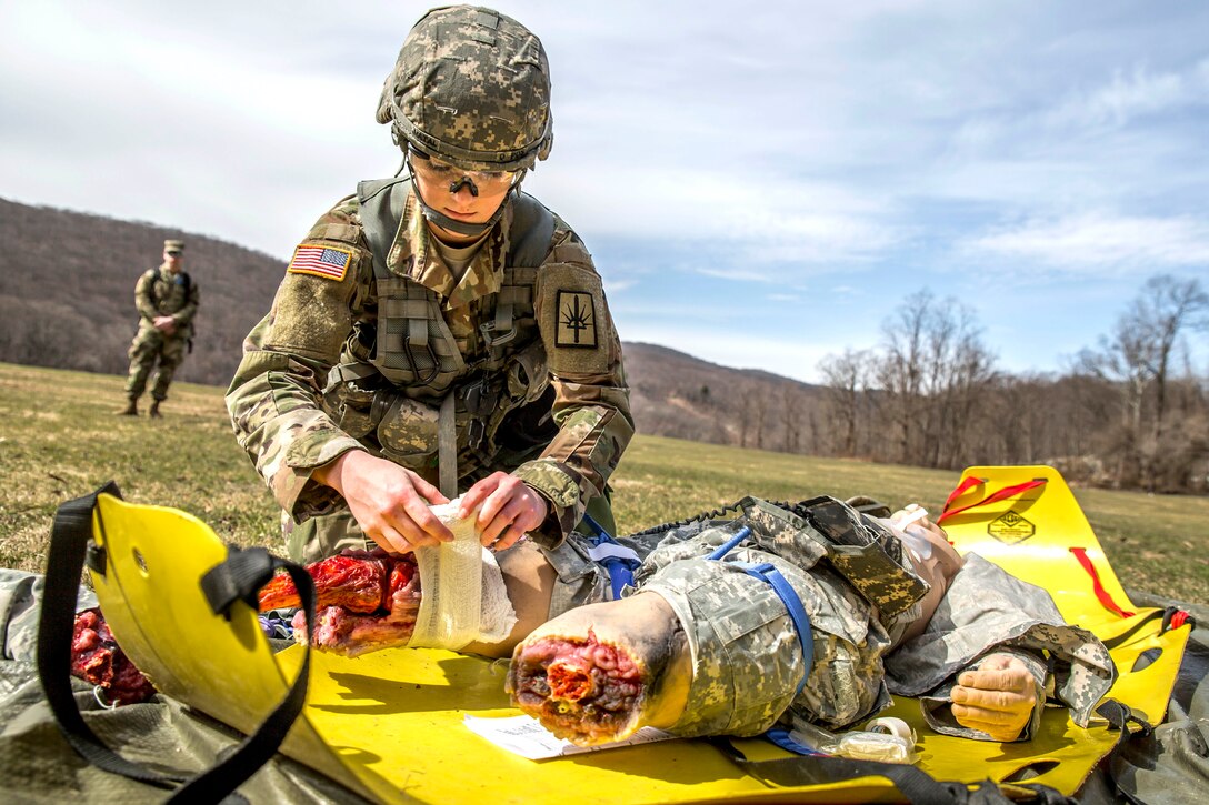 New York Army National Guard Spc. Courtney Natal provides medical aid to a mock casualty during the New York Army National Guard Best Warrior Competition at Camp Smith, New York, March 30, 2017. Army National Guard photo by Sgt. Harley Jelis