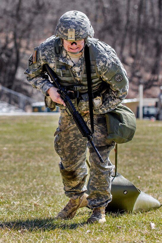 A New York Army National Guardsman drags a weighted sled during the stress shoot lane, which combines physical tests and shooting events, during the New York Army National Guard Best Warrior Competition at Camp Smith, New York, March 30, 2017. Army National Guard photo by Sgt. Harley Jelis 