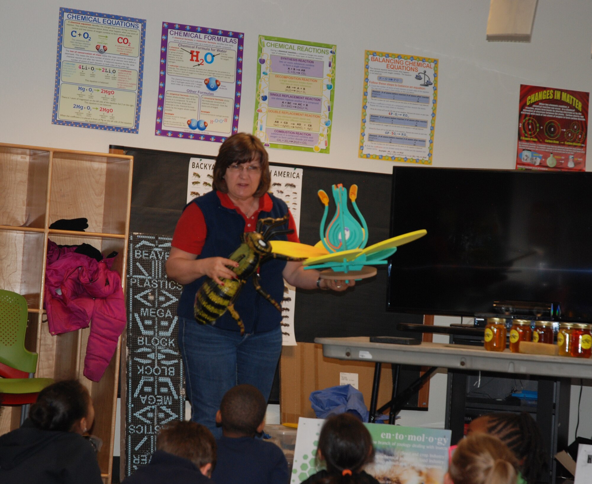PETERSON AIR FORCE BASE, Colo. – Gisele Jefferson, Colorado State University Extension consumer and family agent, uses larger than life models to show a group of children how bees produce honey at one of 10 stations during the CSU Extension’s AgFest event at the R.P. Lee Youth Center, Peterson Air Force Base, Colo., March 27, 2017. The event employed a hands-on approach to use science, technology, engineering and math to help students learn about the importance of agricultural food production(U.S. Air Force Photo by Dave Smith)