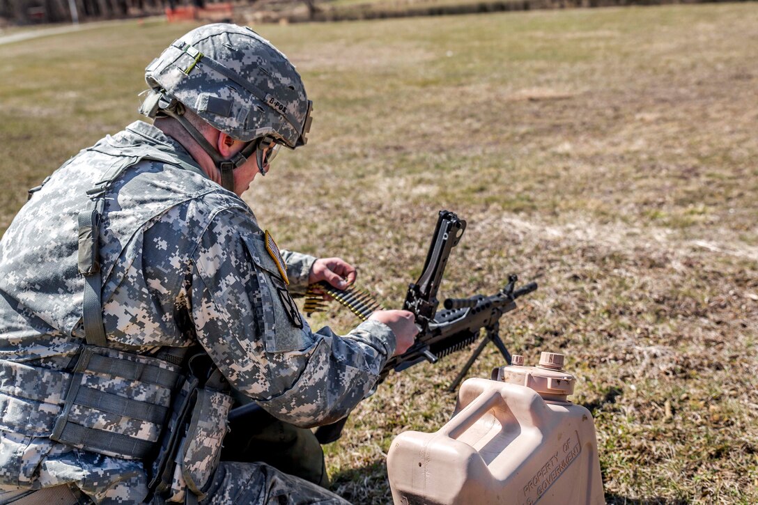 A New York Army National Guardsman loads his M249 light machine gun during the stress shoot lane, which combines physical tests and shooting events, at the New York Army National Guard Best Warrior Competition at Camp Smith, New York, March 30, 2017. Army National Guard photo by Sgt. Harley Jelis
