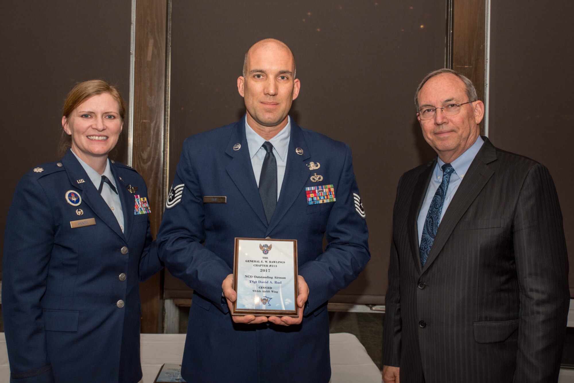 Lt. Col. Lizabeth Wenzel, commander of the Air Force ROTC Detachment 415 at the University of Minnesota, and retired Air Force Lt. Gen. David Deptula, dean of the Mitchell Institute for Aerospace Power Studies, present Tech. Sgt. David Rud, an Explosive Ordnance Specialist with the 934th Airlift Wing, the Non-commissioned Officer Outstanding Airman of the Year Award
 at the Air Force Association’s 2017 Awards Dinner sponsored by the General E. W. Rawlings Chapter, April 7 at the Town & Country Club in St. Paul, Minn. (U.S. Air Force photo by Master Sgt. Eric Amidon)