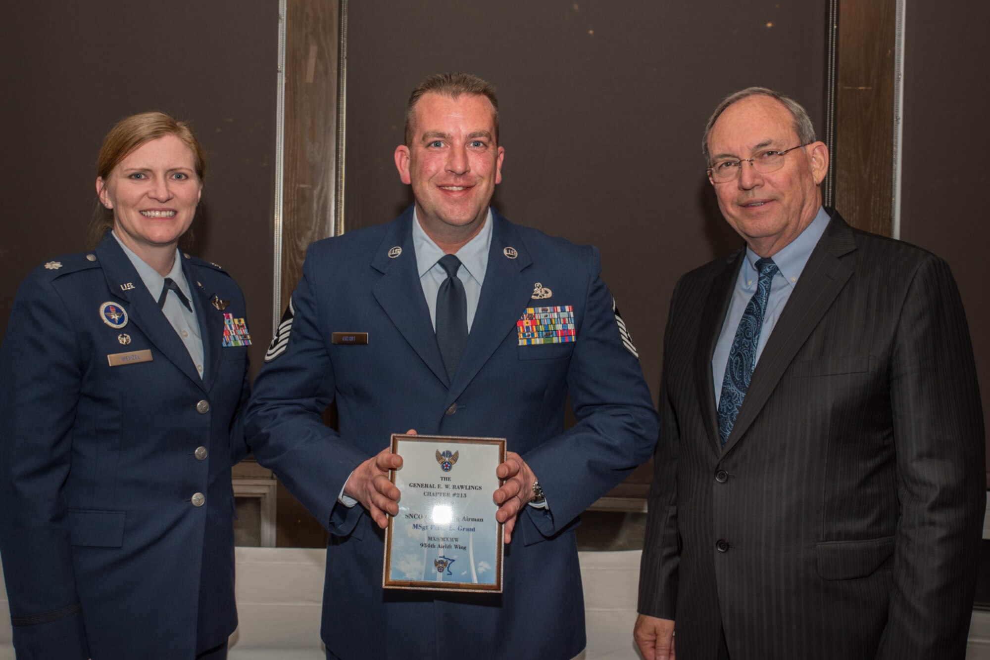 Lt. Col. Lizabeth Wenzel, commander of the Air Force ROTC Detachment 415 at the University of Minnesota, and retired Air Force Lt. Gen. David Deptula, dean of the Mitchell Institute for Aerospace Power Studies, present Master. Sgt. Peter Grant, an Air Reserve Technician (ART) with the 934th Logistics Readiness Squadron
, the Senior Non-commissioned Officer Outstanding Airman of the Year Award at the Air Force Association’s 2017 Awards Dinner sponsored by the General E. W. Rawlings Chapter, April 7 at the Town & Country Club in St. Paul, Minn. (U.S. Air Force photo by Master Sgt. Eric Amidon)
