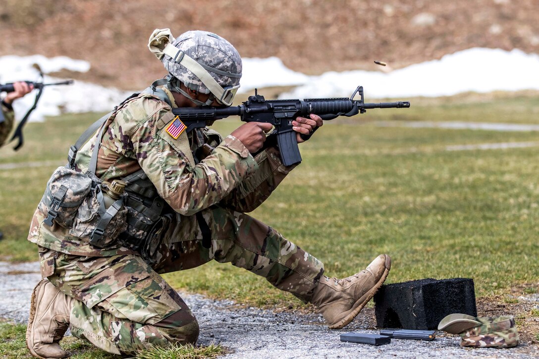 A New York Army National Guardsman fires his M4 carbine from the kneeling position in the weapons qualification event during the New York Army National Guard Best Warrior Competition at Camp Smith, New York, March 30, 2017. Army National Guard photo by Spc. Jonathan Pietrantoni