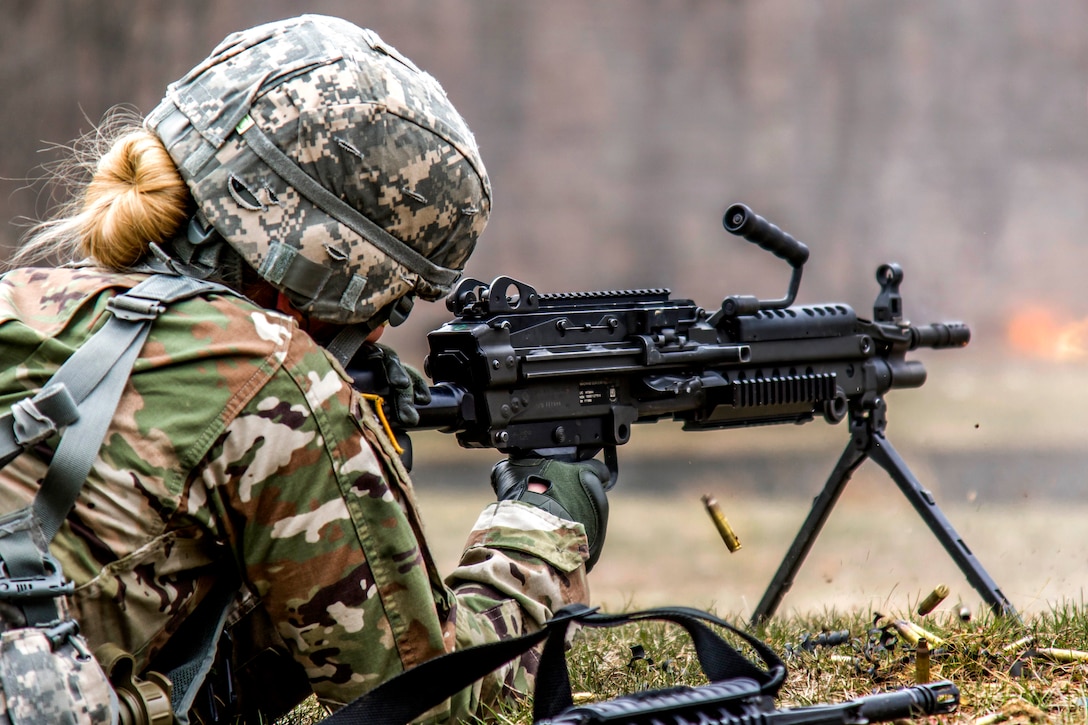 New York Army National Guard Spc. Courtney Natal fires an M249 squad automatic weapon in the stress shoot lane, which combines physical tests and shooting events, during the New York Army National Guard Best Warrior Competition at Camp Smith, New York, March 30, 2017. Army National Guard photo by Spc. Jonathan Pietrantoni