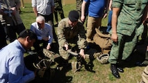Members of the North Atlantic Treaty Organization Land Capability Group on Dismounted Soldier Systems examine a prototype for exoskeleton technology April 5, aboard Marine Corps Base Quantico. During the three-day session, representatives from 20 countries and three continents discussed standardization of common capabilities and issues for coalition Marines and soldiers worldwide. LCG DSS is part of the NATO Army Armaments Group, one of the three main armaments groups subordinate to NATO's Conference of National Armaments Directors. (U.S. Marine Corps photo by Emily Greene)