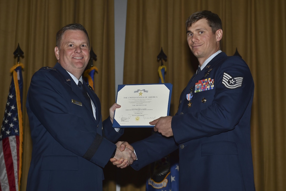 Lt. Gen. Brad Webb, commander of Air Force Special Operations Command, presents Tech. Sgt. Brian Claughsey a Silver Star medal, April 7, 2017, at Pope Army Airfield, N.C. Claughsey is a combat controller with the 21st Special Tactics Squadron.  Air Force photo by Senior Airman Ryan Conroy