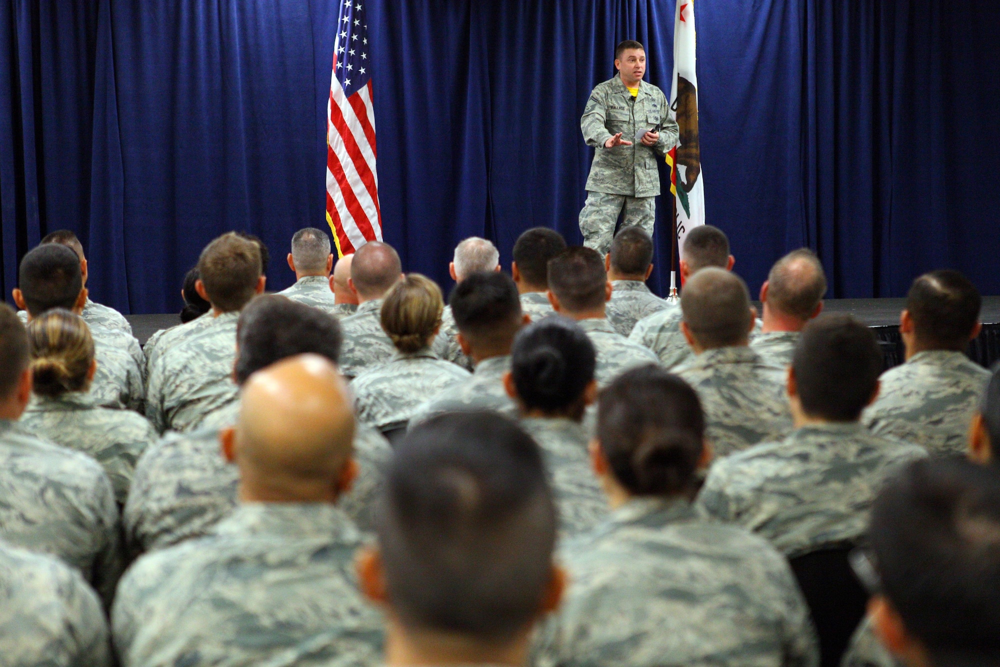 Senior Master Sgt. Kevin Wallace of the 89th Airlift Wing at Joint Base Andrews, Maryland, speaks to enlisted Airmen about resiliency and shares his personal narrative during an enlisted all-call held by the 163d Attack Wing on August 6, 2016, at March Air Reserve Base, California. (Air National Guard Photo by Airman 1st Class Crystal Housman)