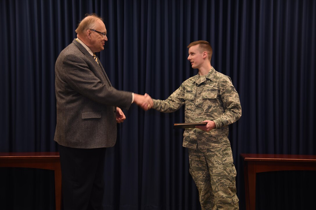 Sioux Falls, S.D. - Staff Sgt. Zac Hakinson, 114th Communication Flight information technology specialist, receives his collage diploma from Dr. Richard Hanson, Dakota State University Provost and Vice President for Academic Affairs, April 11, 2017, Joe Foss Field, S.D. Hakinson received his diploma prior to deploying for a Reserve Component Period. (U.S. Air National Guard photo by Staff Sgt. Duane Duimstra/Released)