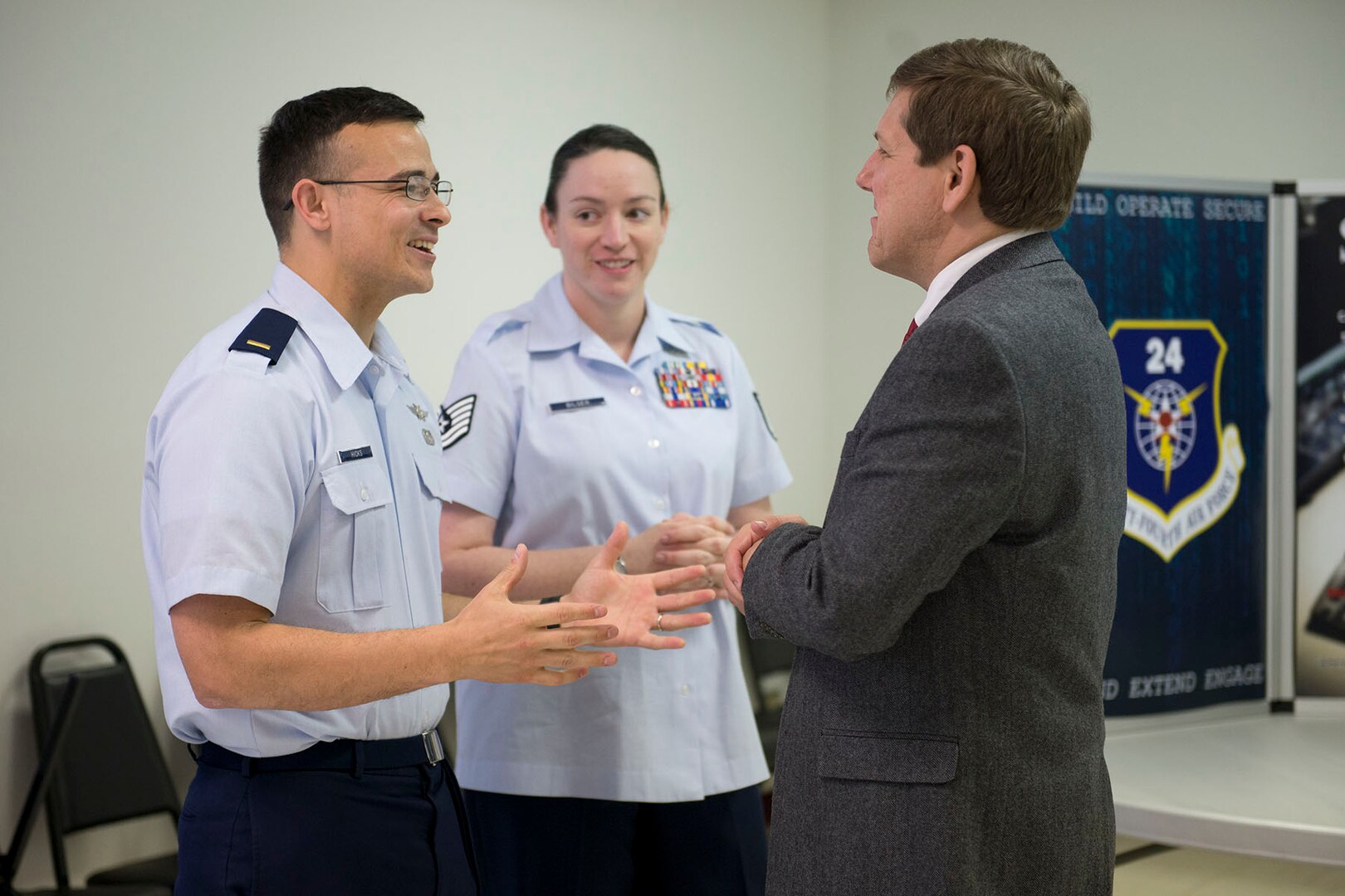 2nd Lt. Nathaniel Hicks, 33rd Network Warfare Squadron, and Tech. Sgt. Kayla Bilger, 624th Operations Center, speak with a guest about their units’ missions and how they fit into the overall 24th Air Force efforts during the 24th AF Community Open House April 6 at Port San Antonio, Texas. The 33rd NWS detects, prevents, and responds to cyber intrusions on the Air Force network, while the 624th OC provides command and control for the 24th Air Force.