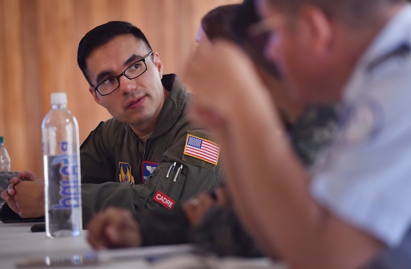 U.S. Air Force Tech. Sgt. Johann Bermudez, U.S. Air Force School of Aerospace Medicine aeromedical evacuation instructor, Wright-Patterson Air Force Base, Ohio, discusses aerospace medicine best practices with members of the Honduran air force as part of a subject matter expert exchange in Tegucigalpa, Honduras, April 4. The global health engagement brought U.S. and Honduran counterparts together to build and strengthen partner relationships.