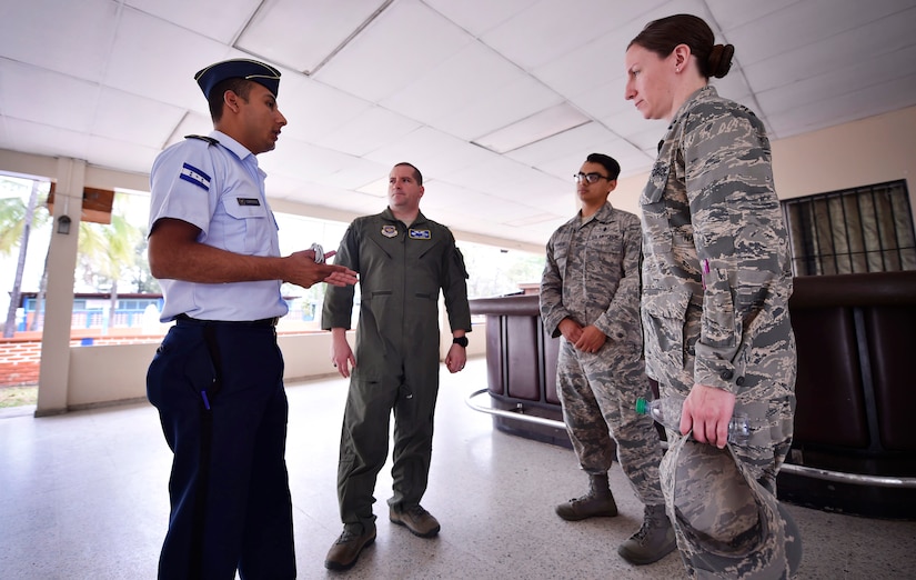 Honduran air force Subteniente Auxiliar Sanidad Obed Antonio Contreres Fuentes, left, talks to U.S. Air Force Capt. Diego Torres, center left, Detachment 4, 375th Operations Group flight nurse instructor and evaluator, Wright-Patterson Air Force Base, Ohio, Staff Sgt. Gabriel Trujillo, center right, 779th Medical Operations Squadron paramedic, Joint Base Andrews, Maryland, and Capt. Leslie Whiting, 88th Aerospace Medicine Squadron aerospace nurse manager, Wright-Patterson Air Force Base, Ohio, as part of a subject matter expert exchange in Tegucigalpa, Honduras, April 4. The global health engagement brought U.S. and Honduran counterparts together to build and strengthen partner relationships.