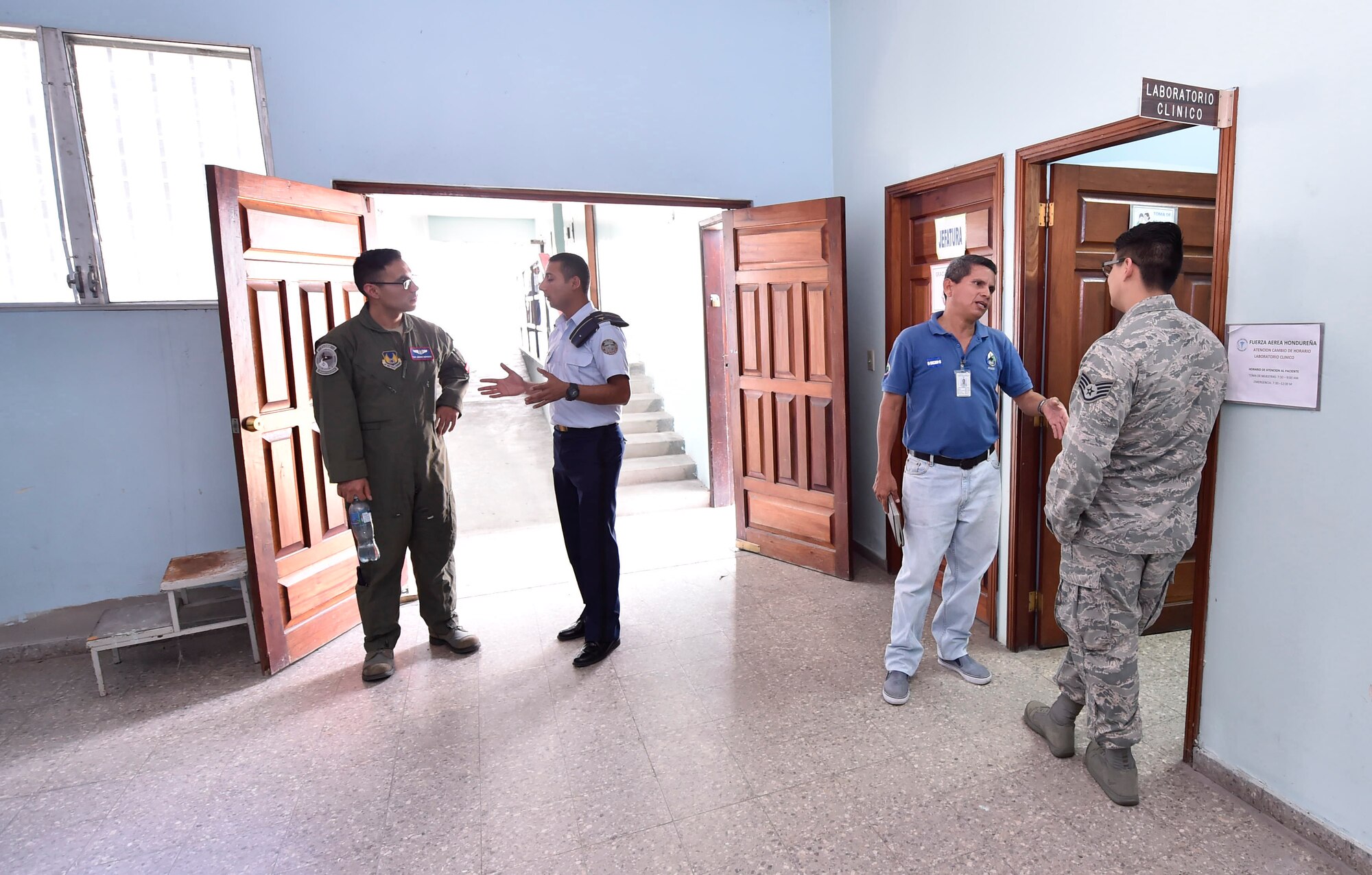 U.S. Air Force Tech. Sgt. Johann Bermudez, U.S. Air Force School of Aerospace Medicine aeromedical evacuation instructor, Wright-Patterson Air Force Base, Ohio, left, and U.S. Air Force Staff Sgt. Gabriel Trujillo, 779th Medical Operations Squadron paramedic, Joint Base Andrews, Maryland, right, tour a Honduran air force medical clinic as part of a subject matter expert exchange in Tegucigalpa, Honduras, April 4. The global health engagement brought U.S. and Honduran counterparts together to build and strengthen partner relationships.