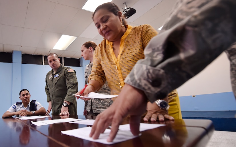 U.S. Air Force and Honduran air force aerospace medicine subject matter experts compare medical administrative forms as part of a subject matter expert knowledge exchange in Tegucigalpa, Honduras, April 5. The global health engagement brought U.S. and Honduran counterparts together to build and strengthen partner relationships.