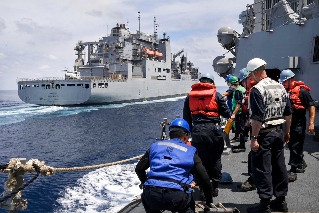 Sailors aboard the guided missile destroyer USS Wayne E. Meyer remove lifelines as they prepare to receive cargo from the dry cargo ship USNS Cesar Chavez during an underway replenishment in the South China Sea, April 3, 2017. Wayne E. Meyer is on a regularly scheduled Western Pacific deployment with the Carl Vinson Carrier Strike Group. Navy photo by Petty Officer 3rd Class Kelsey L. Adams