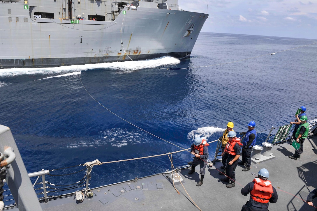 Sailors aboard the guided missile destroyer USS Wayne E. Meyer heave a messenger line from the dry cargo ship USNS Cesar Chavez during an underway replenishment in the South China Sea, April 3, 2017. Navy photo by Petty Officer 3rd Class Kelsey L. Adams