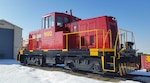 A retired Army locomotive sits atop a flat car for its move to Lake Providence, Louisiana and it's second career. 