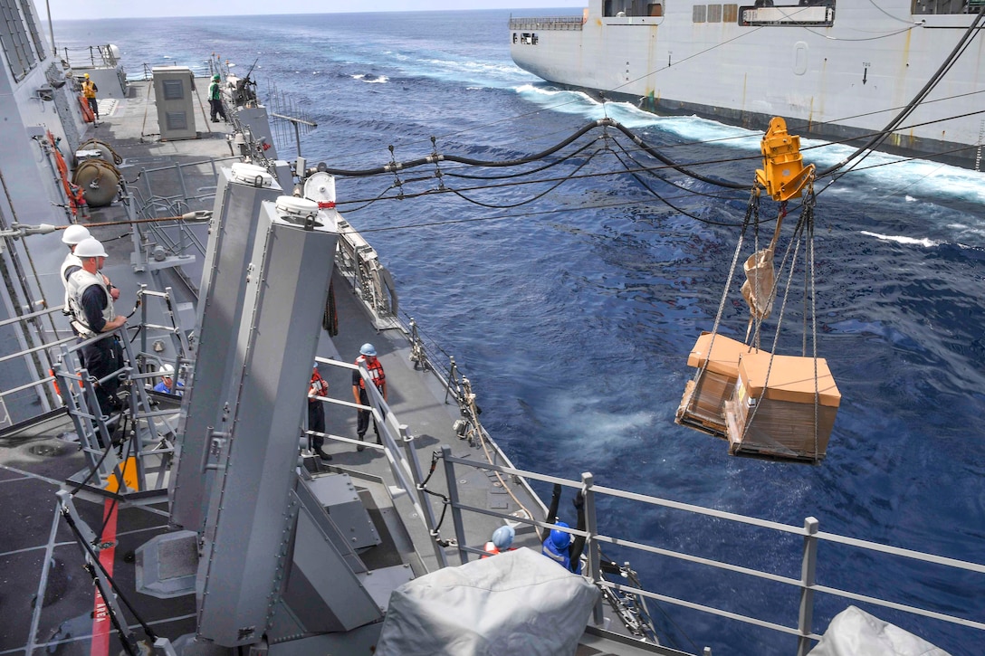 Sailors aboard the guided missile destroyer USS Wayne E. Meyer receive cargo from the dry cargo ship USNS Cesar Chavez during an underway replenishment in the South China Sea, April 3, 2017. Navy photo by Petty Officer 3rd Class Kelsey L. Adams