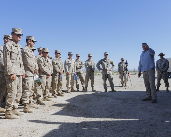 Mr. Brian Long, project officer for the Joint Non-Lethal Weapons Directorate briefs Marines on the Active Denial System during Weapons and Tactics Instructor course (WTI) 2-17 at Site 50, Wellton, Ariz., April 4, 2017. The Aviation Development, Tactics and Evaluation Department and Marine Operational Test and Evaluation Squadron One (VMX-1) Science and Technology Departments conducted the tactical demonstration to explore and expand existing capabilities. MAWTS-1 provides standardized advanced tactical training and certification of unit instructor qualifications to support Marine Aviation Training and Readiness and assist in developing and employing aviation weapons and tactics. (U.S. Marine Corps photo by Lance Cpl. Andrew M. Huff)